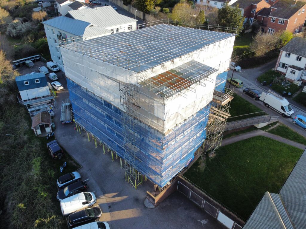 Failed Cavity Wall Insulation Extraction South West Specialists Photo of Teign Housing Flats Aerial View Showing scaffolding cover during works